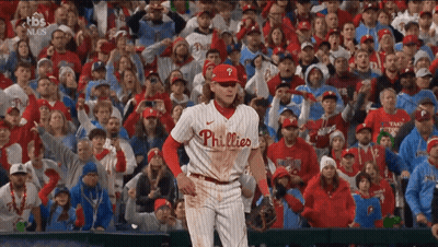A Phillies Baseball Player Stands In Front Of A Crowd Of People GIF