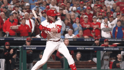 A Phillies Baseball Player Swings His Bat At The Ball GIF
