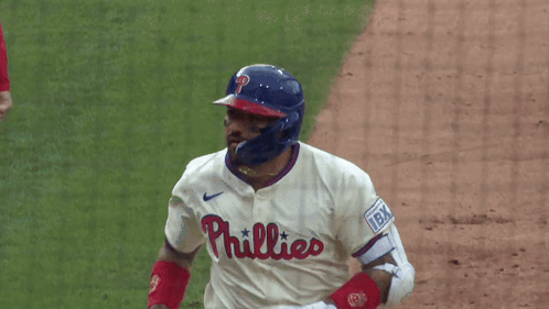 A Phillies Baseball Player Wearing A Helmet And White Jersey GIF