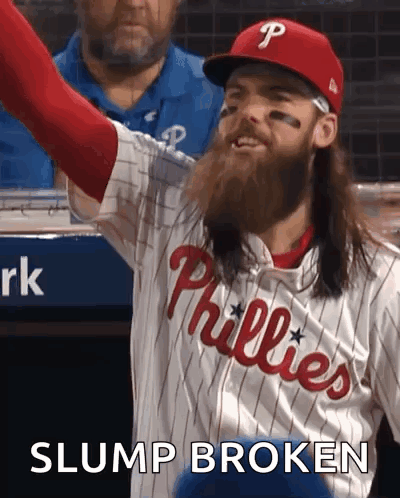 A Phillies Baseball Player With Long Hair And A Beard Is Celebrating GIF