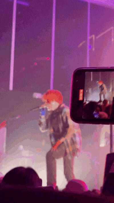 A Phone Is Taking A Picture Of A Man On Stage GIF