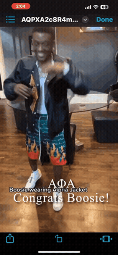 A Phone Screen Shows A Man Wearing A Jacket And Shorts And Says Boosie Wearing Alpha Jacket Congrats Boosie GIF