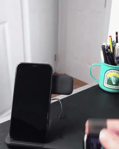 A Phone Sitting On A Desk Next To A Mug That Says Rainwater Valley National Park GIF