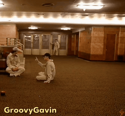 A Photo Of A Man Sitting On The Floor With Groovy Gavin Written On The Bottom GIF