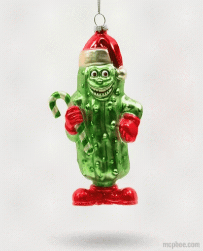 A Pickle Ornament With A Santa Hat And Candy Cane GIF