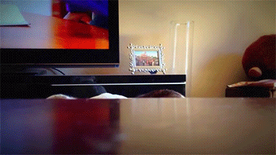A Picture Frame On A Table Next To A Television GIF