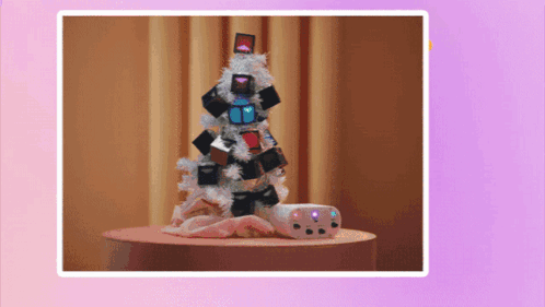 A Picture Of A Christmas Tree With Gifts On It GIF
