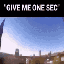 A Picture Of A City With The Words " Give Me One Sec " GIF