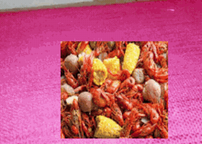 A Picture Of A Crawfish Boil With Corn And Potatoes GIF