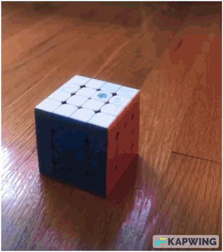 A Picture Of A Cube On A Wooden Floor With Kapwing Written In The Corner GIF