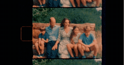 A Picture Of A Family Sitting On A Rock With A Black Background GIF