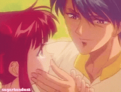 A Picture Of A Man Kissing A Girl With Sugarbundust Written On The Bottom Right GIF