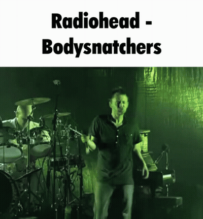 A Picture Of A Man On Stage With The Words Radiohead Bodysnatchers GIF
