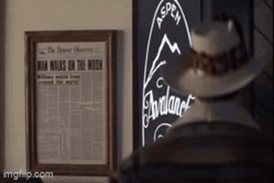 A Picture Of A Man Walking On The Moon Is Hanging On A Wall GIF