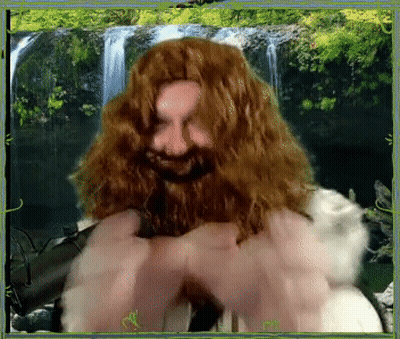 A Picture Of A Man With A Beard And Long Hair In Front Of A Waterfall GIF