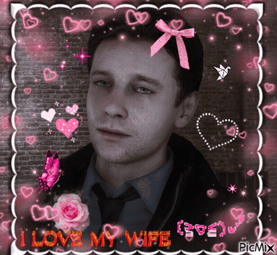 A Picture Of A Man With A Pink Bow On His Head And The Words " I Love My Wife " GIF