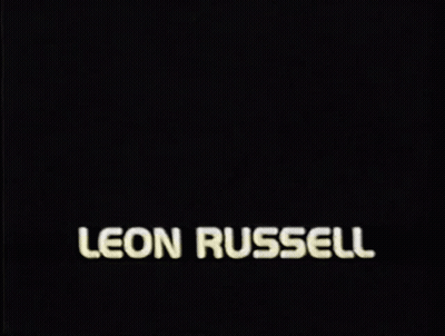 A Picture Of A Man With The Name Leon Russell On The Bottom GIF