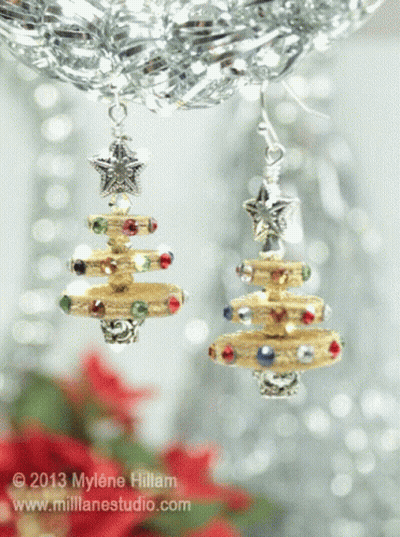 A Picture Of A Pair Of Christmas Tree Shaped Earrings Taken In 2013 GIF