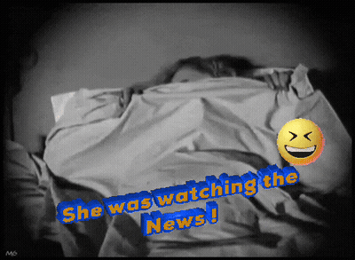 A Picture Of A Person Laying In Bed With The Words She Was Watching The News Written On It GIF