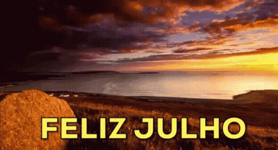 a picture of a sunset over the ocean with the words feliz julho