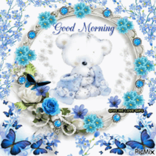 A Picture Of A Teddy Bear Surrounded By Blue Flowers And Butterflies GIF