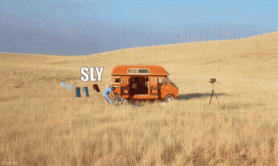 A Picture Of A Van In A Field With The Words Sly On It GIF
