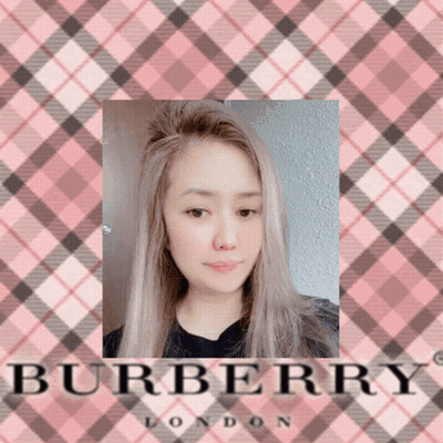 A Picture Of A Woman In Front Of A Pink Burberry London Logo GIF