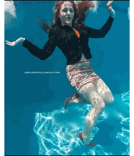 A Picture Of A Woman Underwater With The Website Splashofglamour.com Visible Sticker