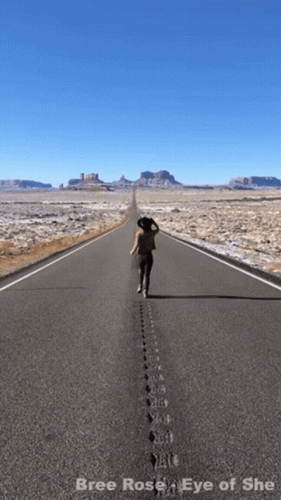 A Picture Of A Woman Walking Down An Empty Road With The Words Bree Rose Eye Of She Below Her GIF
