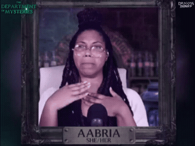 A Picture Of A Woman With Glasses And A Sign That Says Aabri She / Her GIF