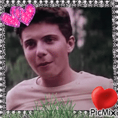 A Picture Of A Young Man With Two Pink Hearts And A Red Heart On The Bottom Right GIF