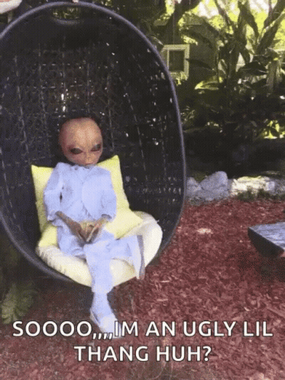 A Picture Of An Alien Sitting In A Chair With The Caption Soooo Im An Ugly Lil Thang Huh ? GIF