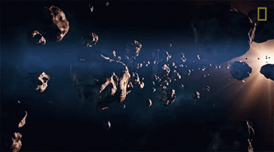 A Picture Of Asteroids In Space With A National Geographic Logo In The Upper Left Corner GIF