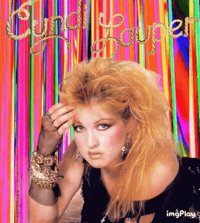 A Picture Of Cyndi Lauper With A Rainbow Background GIF
