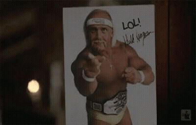 A Picture Of Hulk Hogan Pointing At The Camera With A Signature On It . GIF
