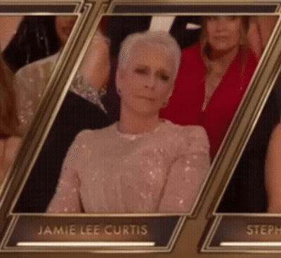 A Picture Of Jamie Lee Curtis Sitting In A Row With Other People GIF