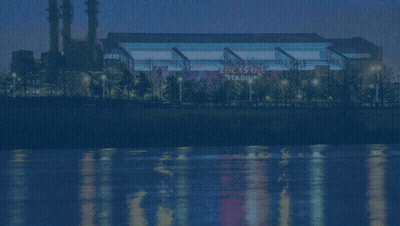 A Picture Of Lucas Oil Stadium With A River In The Background GIF