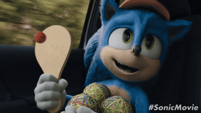 A Picture Of Sonic The Hedgehog Holding A Paddle And Balls GIF