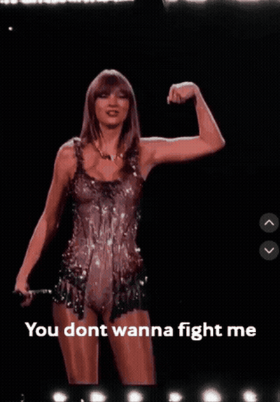 A Picture Of Taylor Swift Flexing Her Muscles With The Words You Dont Wanna Fight Me Below Her GIF