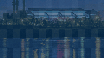 A Picture Of The Indianapolis Colts Stadium With A River In The Background GIF