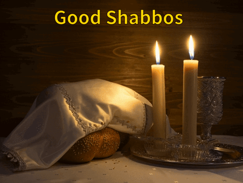 A Picture Of Two Lit Candles And A Loaf Of Bread With The Caption Good Shabbos GIF
