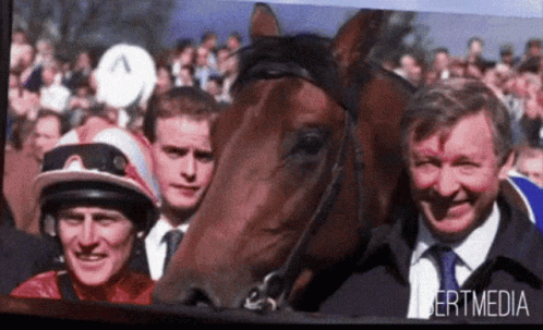 A Picture Of Two Men And A Horse With Bertmedia Written On It GIF