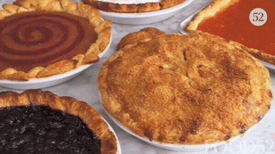 A Pie With The Number 52 On It Sits On A Table Next To Other Pies GIF