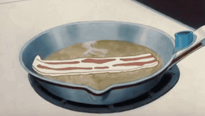 A Piece Of Bacon Is Being Cooked In A Pan GIF