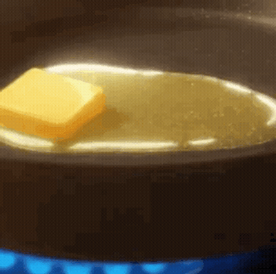 A Piece Of Butter Is Being Melted In A Pan Of Oil . GIF