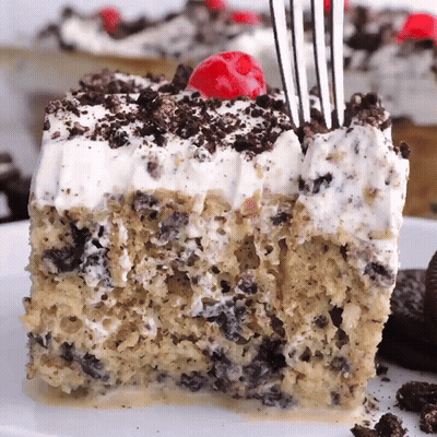 A Piece Of Cake With A Cherry On Top And A Fork In It GIF