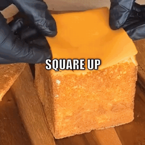 A Piece Of Cheese Is Being Placed On A Piece Of Bread With The Words Square Up Below It GIF