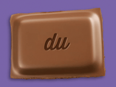 A Piece Of Chocolate With The Word Du Written On It GIF