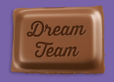A Piece Of Chocolate With The Words Dream Team Written On It GIF