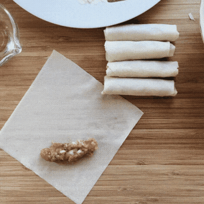 A Piece Of Meat Is Being Wrapped In A Napkin GIF